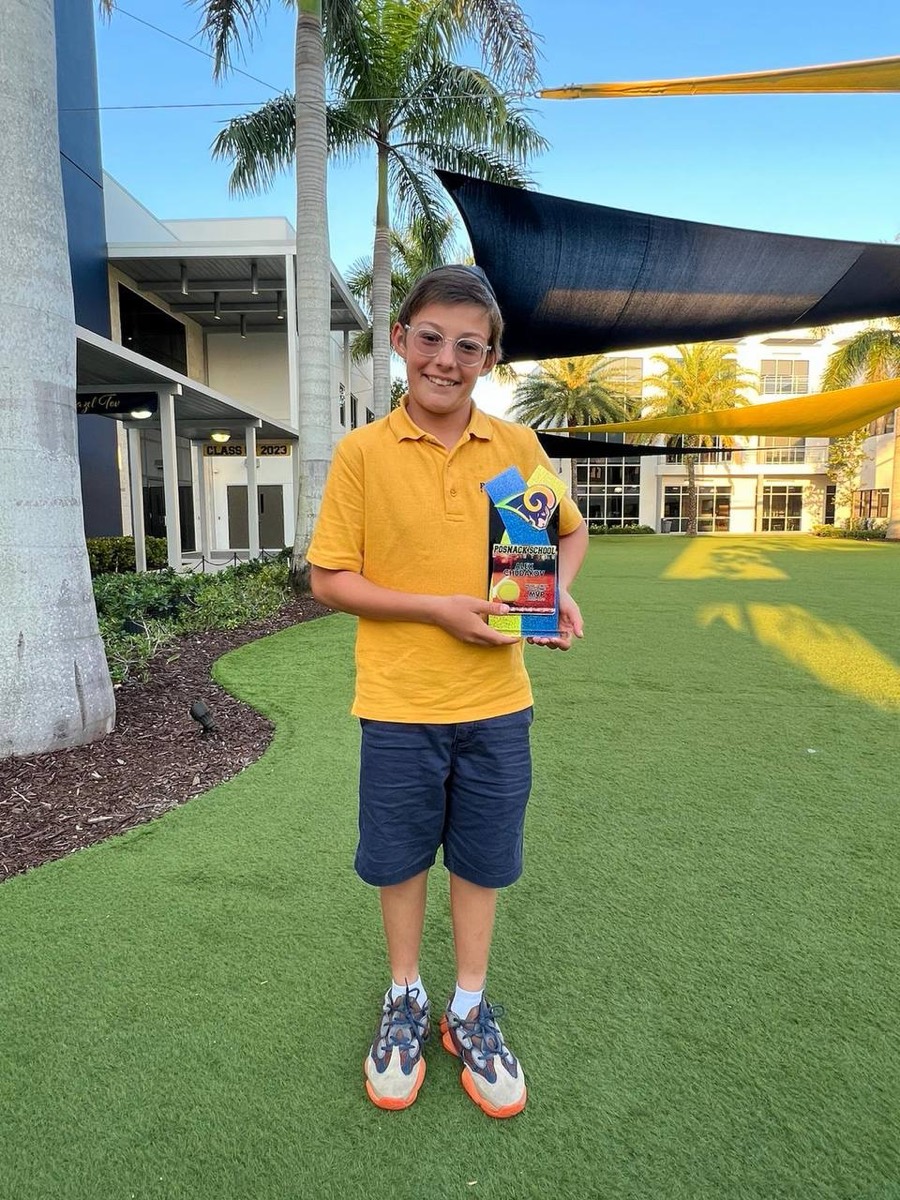 Alex holding a Posnack School MVP award trophy